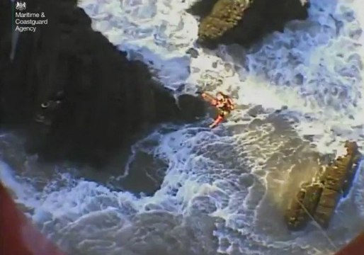 Coastguard Winchman Battered by Waves as He Rescues Men Clinging to Rocks