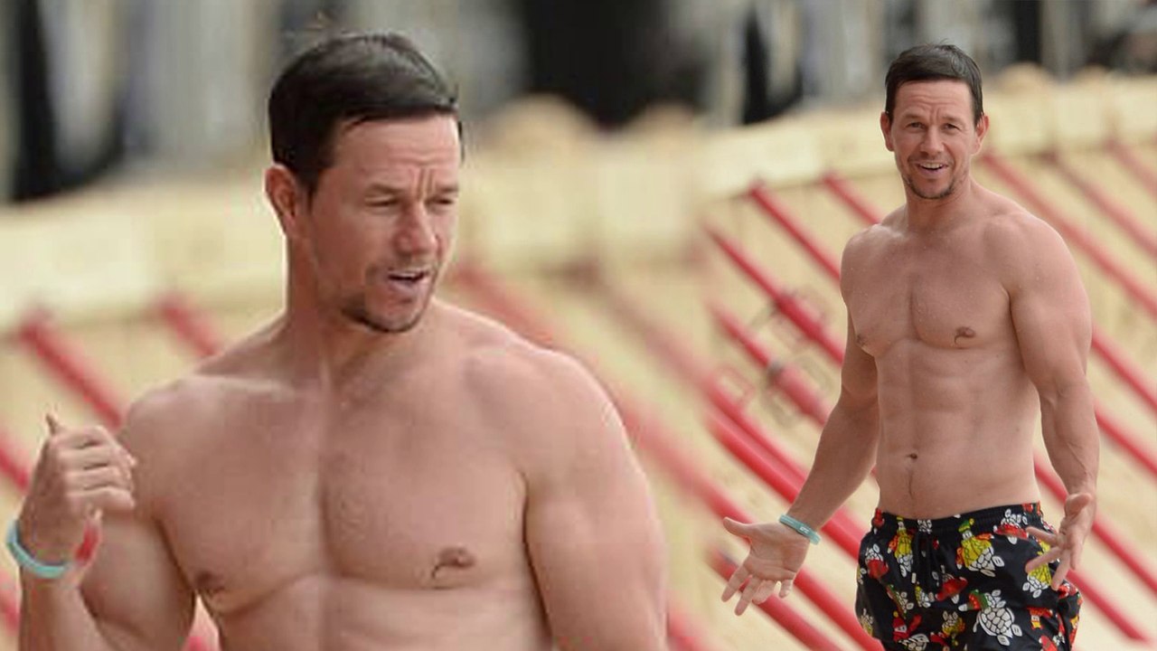 No dad bod here! Mark Wahlberg, 46, shows off his sculpted abs as he relaxes on the beach in Barbados.