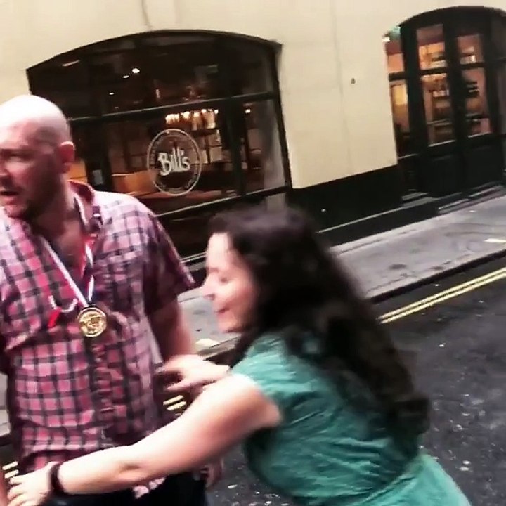 Guy Tries to Lift Girl in the Air in the Middle of the Street