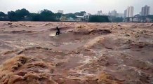 Surfer Rides Waves in Overflowing River