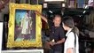 Thai citizens honour their late King by framing his portrait