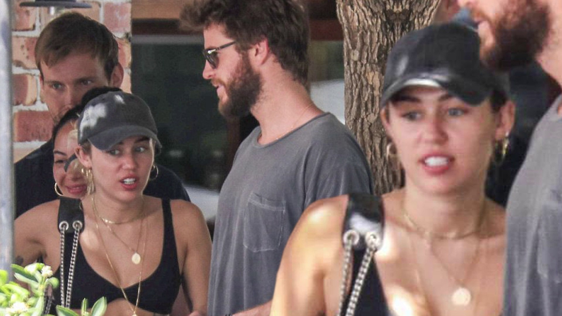 Miley Cyrus flaunts her slender figure in a skimpy bikini top and Daisy Dukes during a relaxed lunch