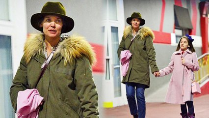 Girl time! Doting mom Katie Holmes holds hands with daughter Suri Cruise as they bundle up for dinner in New York City.