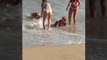 Beachgoer Struggles To Stand Up in Shallow Water