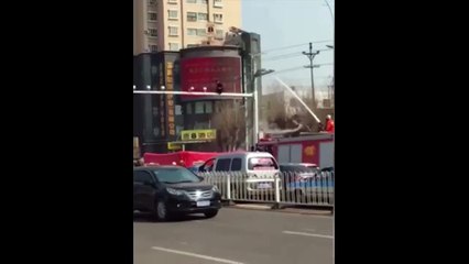 Firefighters remove crazy guy from atop street pole