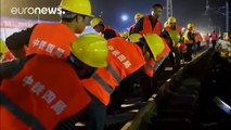 Full steam ahead: Chinese workers lay new railway track in just hours