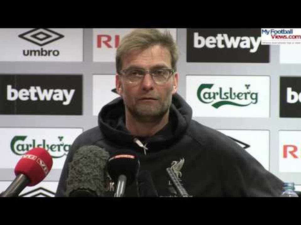 Jurgen Klopp checks his appendix wound mid press conference