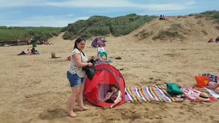 Woman Falls in Hole in Sand