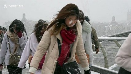 Tourists hit by blizzard conditions as they cross River Thames