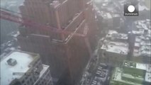 Moment huge crane smashes down on NY street