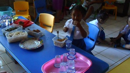 Funny children keeps eating while the other children play