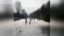 People go ice skating on frozen canals in the Netherlands