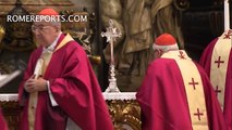 Pope Francis prays for Cardinal Law in front of his remains