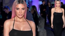 Bust move! Kim Kardashian puts her cleavage on display in plunging black dress at Hollywood music release party
