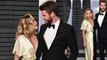 Miley Cyrus slips into plunging gold dress as she party-hops to Vanity Fair Oscar Party with fiancé Liam Hemsworth... after wowing in silver glittery gown for Elton John's bash