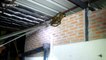 Snake catchers struggle to pull python off of roof