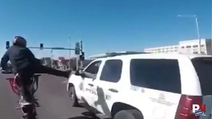 Biker High Fives A Cop As He Wheelies Down The Road