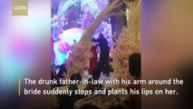 Father plants kiss on son's bride in front of wedding guests