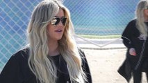 She's a benchwarmer! Pregnant Khloe Kardashian cheers on her family at charity softball game from the sidelines.
