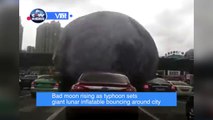 Bad moon rising as typhoon sets giant lunar inflatable bouncing around city
