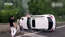Passersby save couple trapped in overturned car on fire