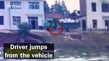 Watch: Fearless driver plunges truck full of rocks into floodwaters to stem breached levee