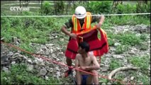 Watch: firefighters rescue trapped man in flood