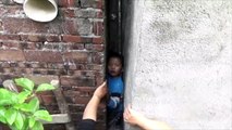 Naughty boy gets stuck between narrow walls