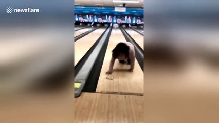 Hilarious moment US woman falls over while bowling