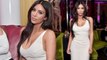 Kim Kardashian shows off her hourglass curves in skintight white dress for pal Lorraine Schwartz's jewellery launch.