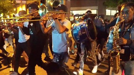 'Impromptu' second line parade walked from Benson's former neighborhood to statue