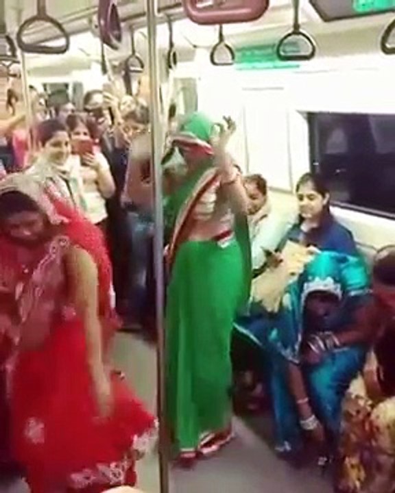 women dancing in Delhi Metro