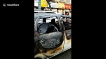 Woman drives burnt-down car on road