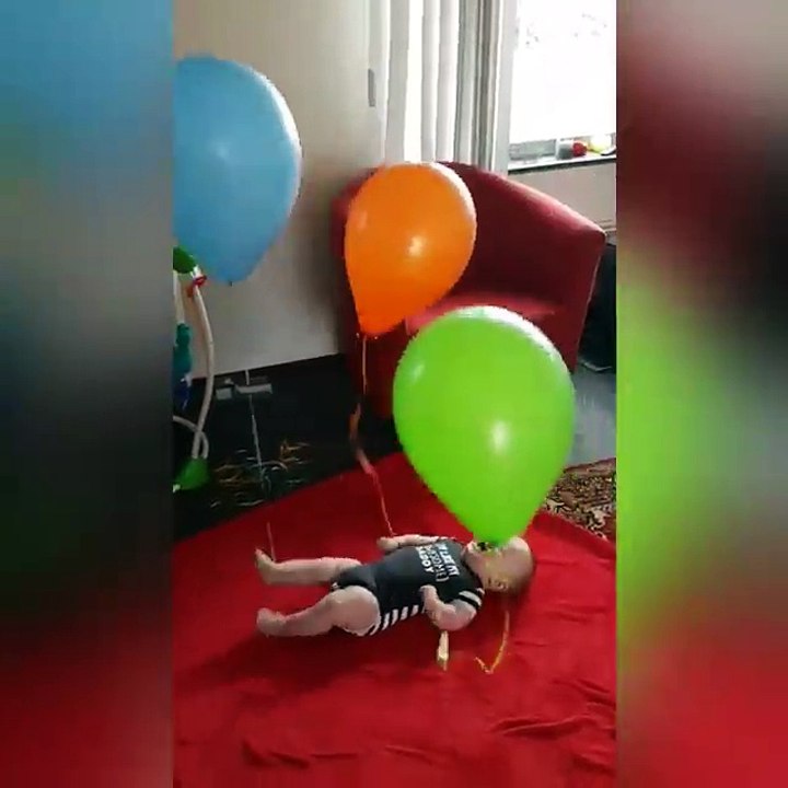 baby playing with baloon