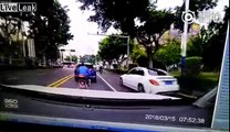 Man on a scooter brake checks a car and drives off. Driver chases and crashes into him