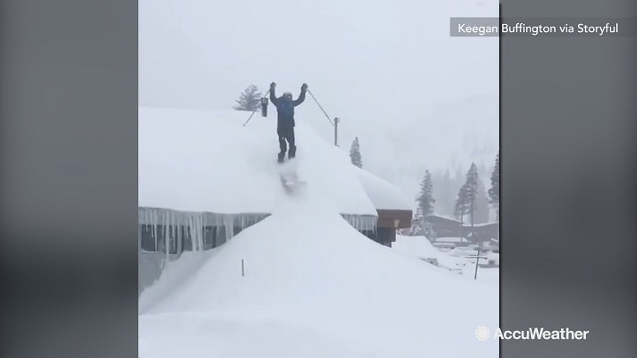 Thrill seeker skis off roof into deep powder of snow
