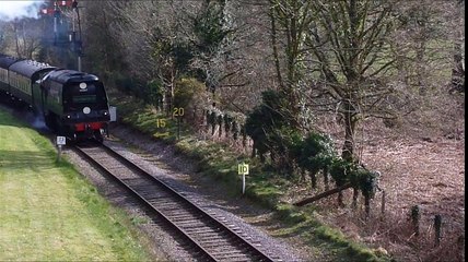Steam Train Slowly Building up Speed after Leaving Railway Train Station