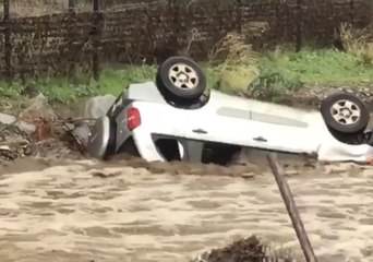 Fast-Moving Water Pushes Vehicle into Gully
