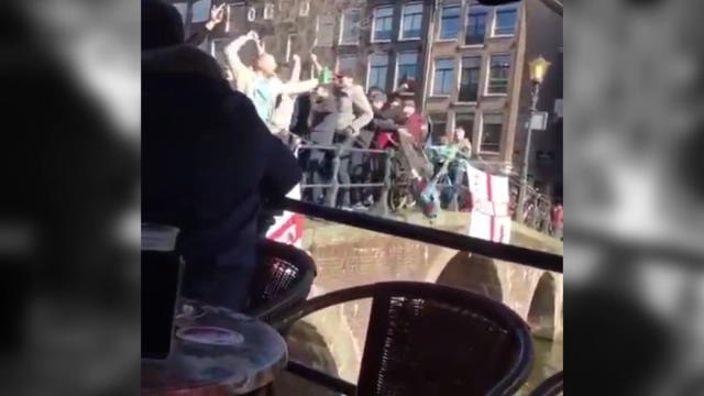 England fans throw beer and a bike into Amsterdam canal