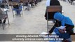 Afghan mum cradling baby during university exam goes viral