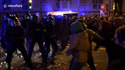 Riot police clash with demonstrators in Barcelona after leader is held