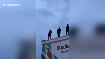 Sculptures of men standing on London building raise awareness on suicide