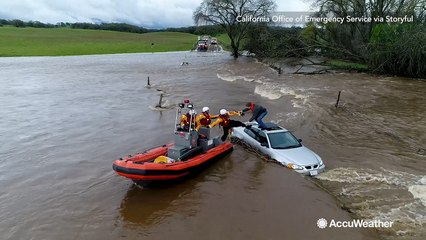Dramatic rescue of man stranded on car roof during severe flood