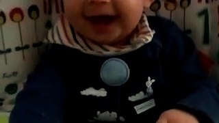 Cute baby laughing hysterically at mommy's hands