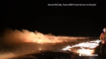 Night video shows Texas firefighters using 'burning out' technique to battle wildfire