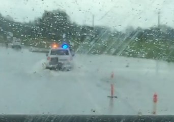 Download Video: Police Escort Trucks through Floodwaters Near Ingham