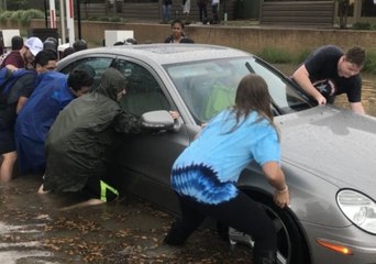 Students Push Car Out of Flooded Street in College Station
