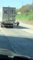 Cyclist Hitches Ride on Semi Truck on Highway