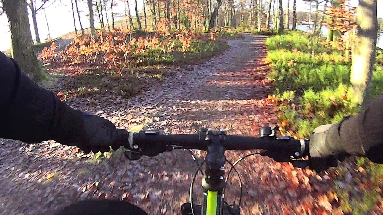 G-Force instructor Andreas Jimmy mountainbiking in the beautiful winter scenery next to a lake.