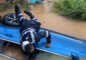 Fijian Police Smash Window of Car Partially Submerged by Floodwaters